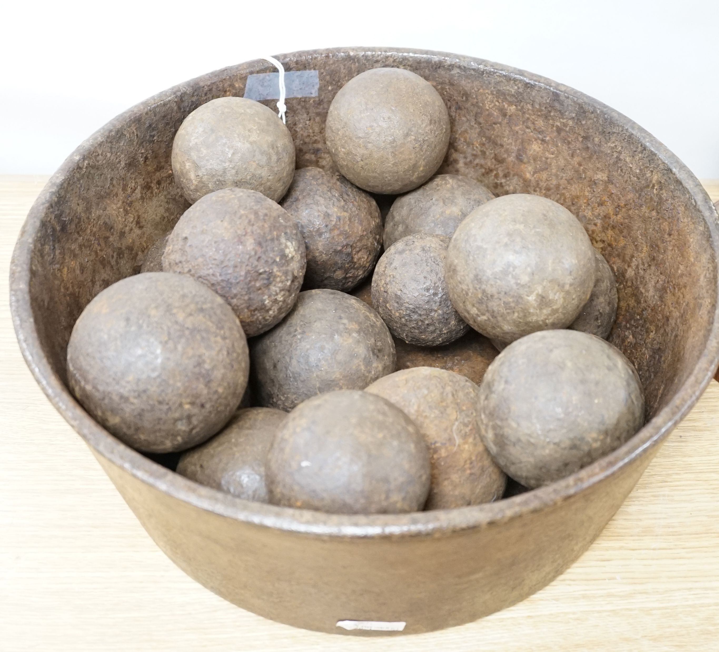 18 iron cannon balls in an iron bowl